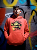 Man wearing red streetwear hoodie with graffiti smile graphic design in urban wall setting