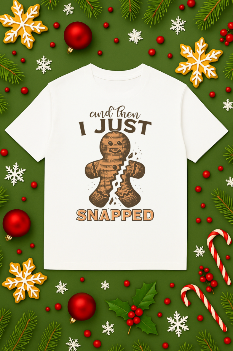 White Christmas t-shirt with a cracked gingerbread man graphic and “And Then I Just Snapped” text, displayed on a festive green background with ornaments, candy canes, and snowflakes.