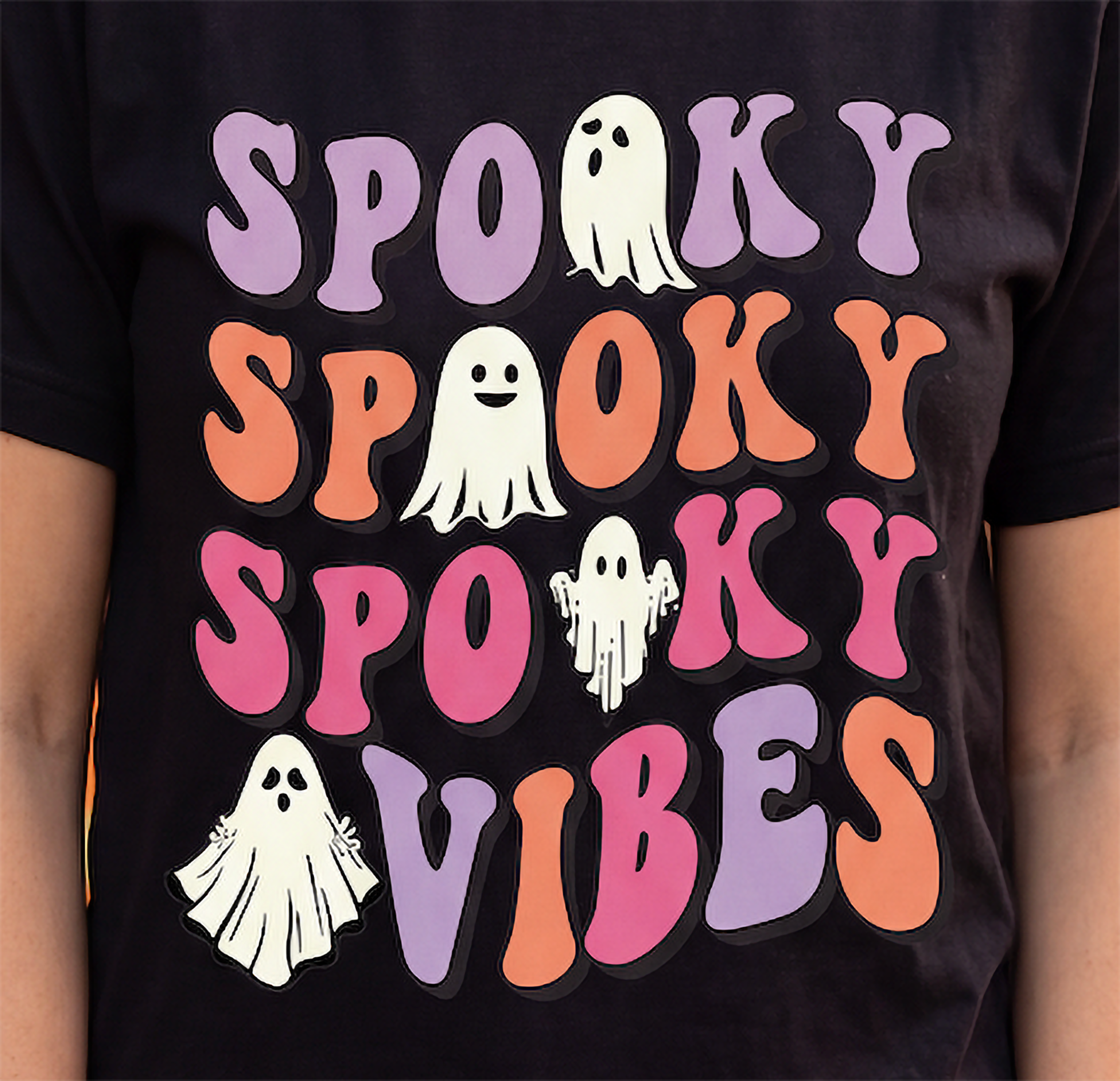 Close-up of Spooky Spooky Spooky Vibes Halloween graphic with purple, orange and pink lettering and four ghosts