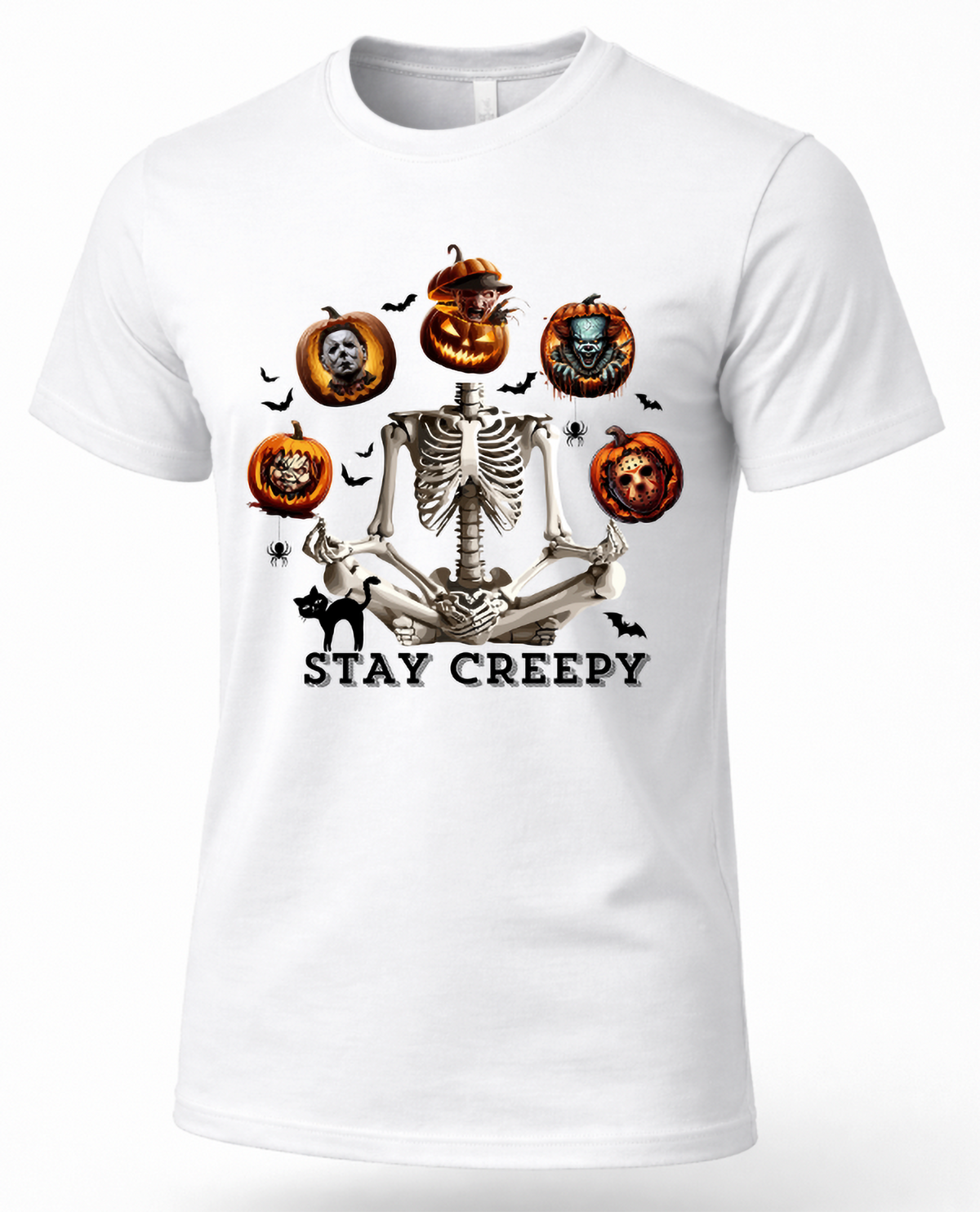 A white short-sleeve crewneck t-shirt featuring a Halloween graphic of a skeleton meditating, surrounded by jack-o'-lanterns, bats, a black cat, and the text 'STAY CREEPY'.