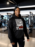 Woman wearing black hoodie with funny gym quote “Straight Outta Shape But I’m Trying” fitness hoodie in gym
