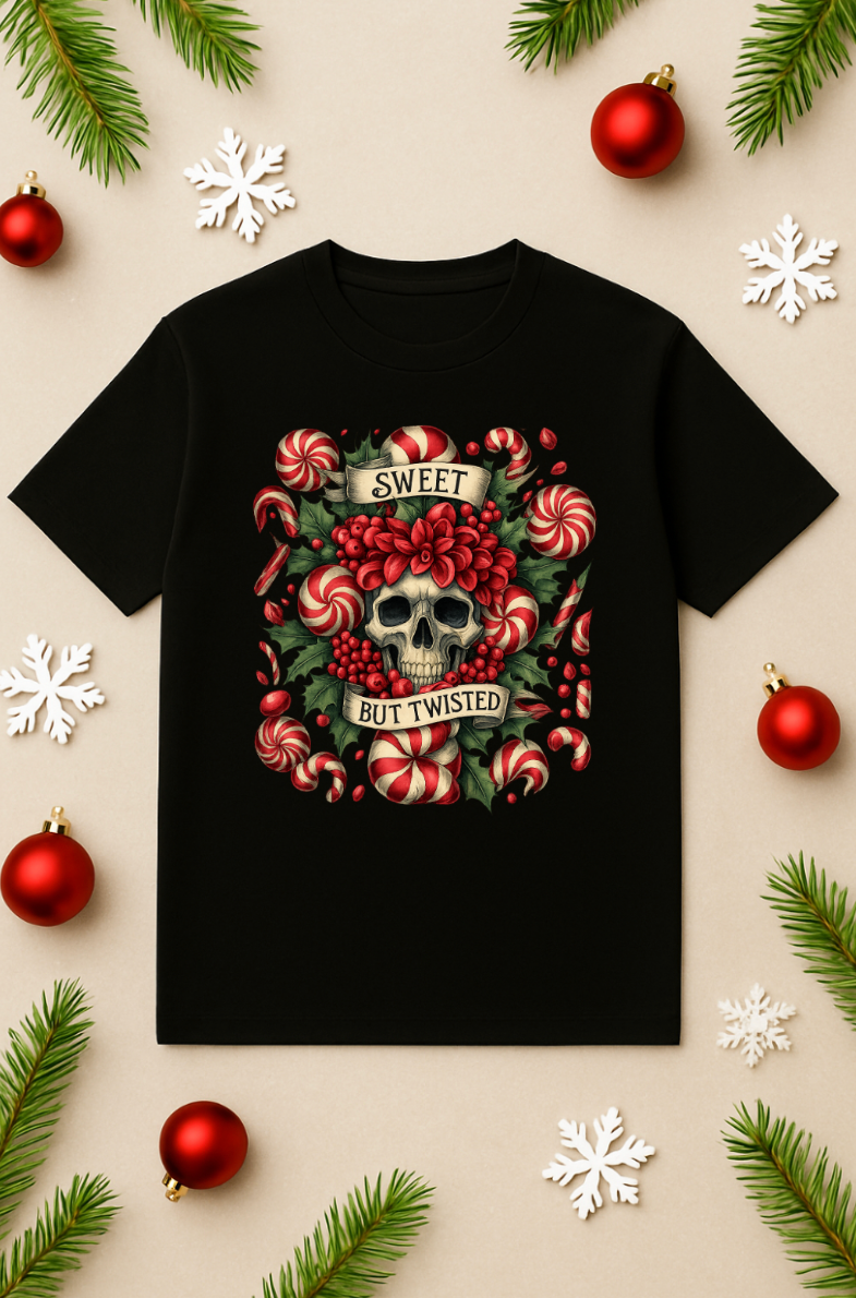 Black Christmas t-shirt featuring a skull with candy canes and holly, holiday flat-lay with ornaments, pine branches, and snowflakes.