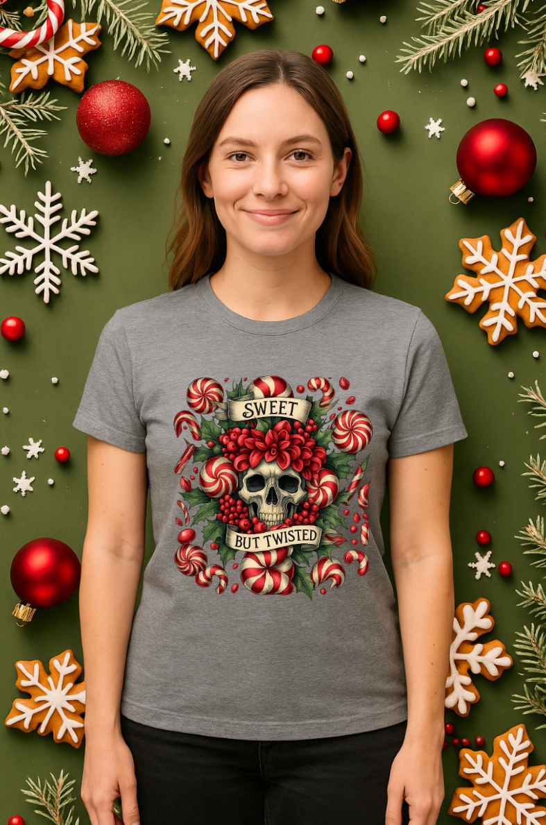 Woman wearing a gray Christmas skull t-shirt with peppermint candy design, standing in a festive holiday background with ornaments and snowflakes.