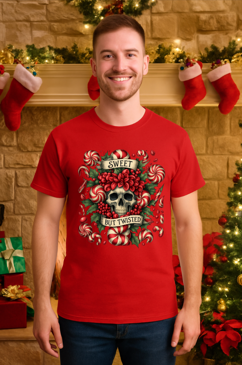 Man wearing a red Christmas t-shirt featuring a skull and candy cane ‘Sweet But Twisted’ design, standing in a festive holiday living room with stockings and garland.