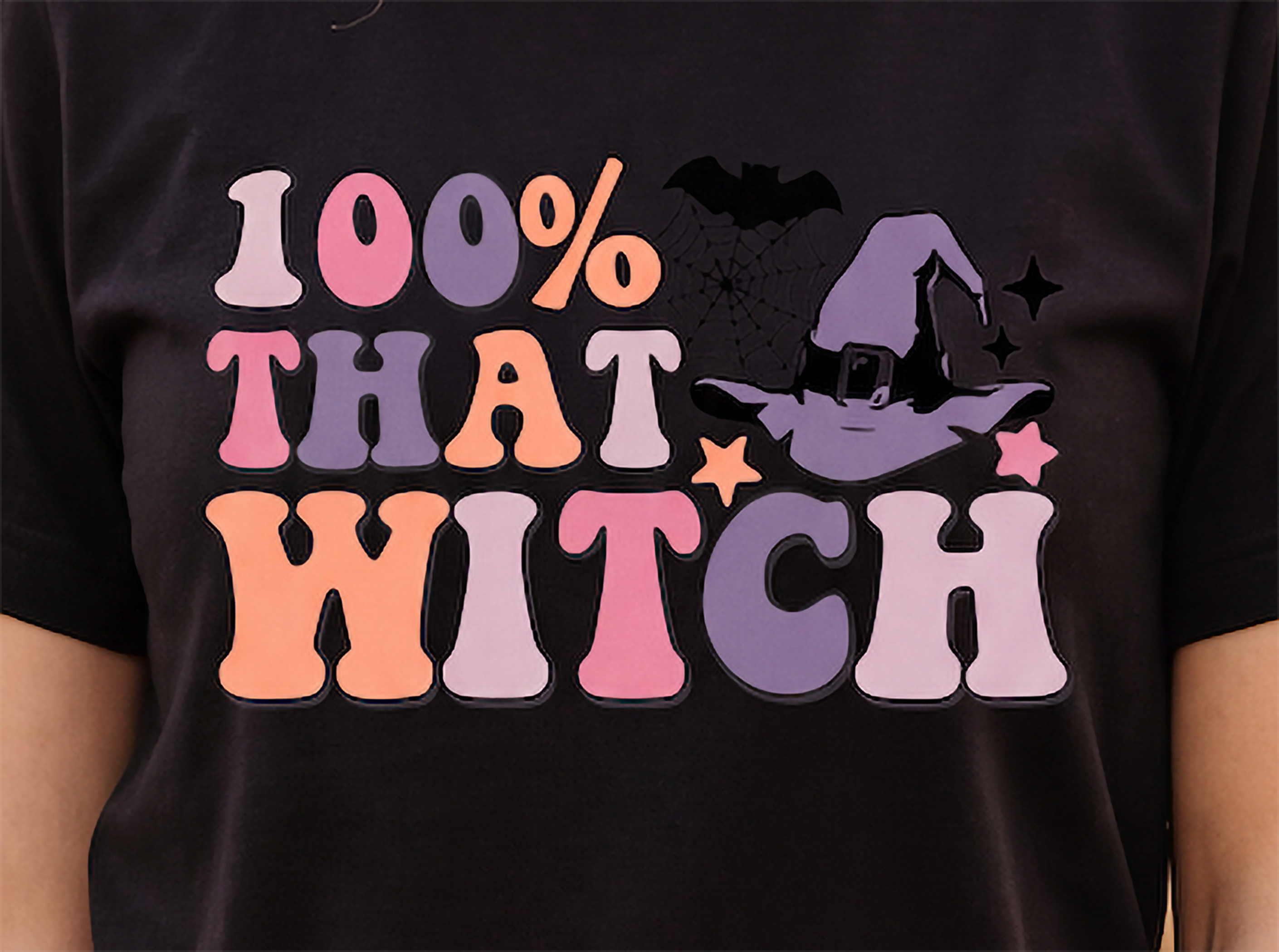 Close-up of 100% That Witch retro Halloween graphic with witch hat spiderweb and bat