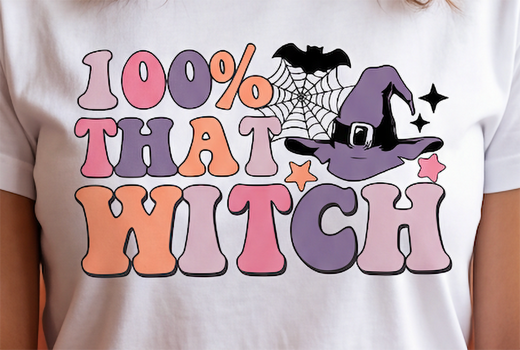 Close-up of 100% That Witch graphic on white shirt with retro lettering and witch hat