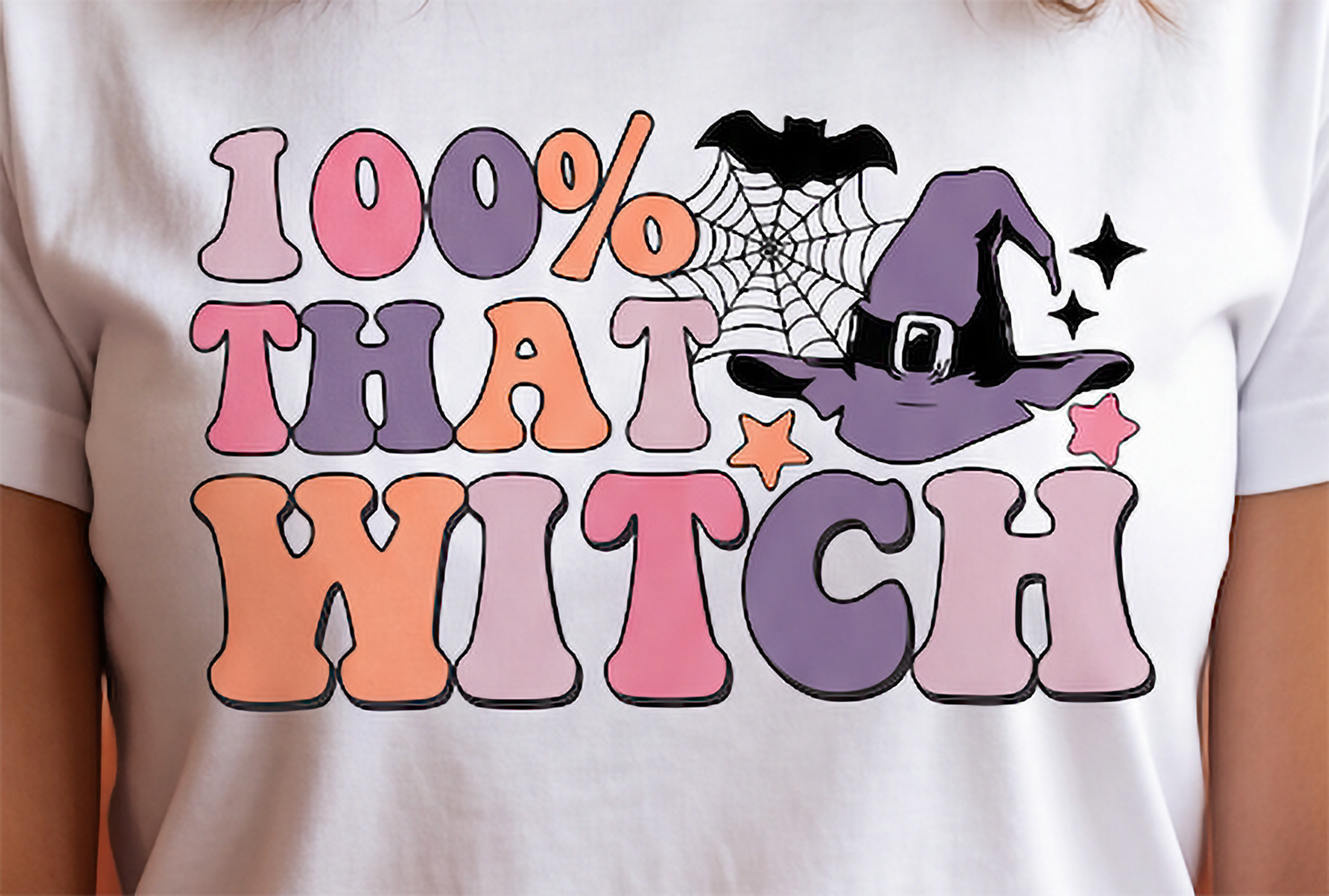 Close-up of 100% That Witch graphic on white shirt with retro lettering and witch hat