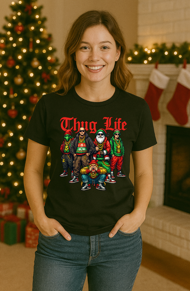 Black “Thug Life” Christmas crew graphic tee displayed on a model standing in front of a decorated Christmas tree and festive holiday scene.