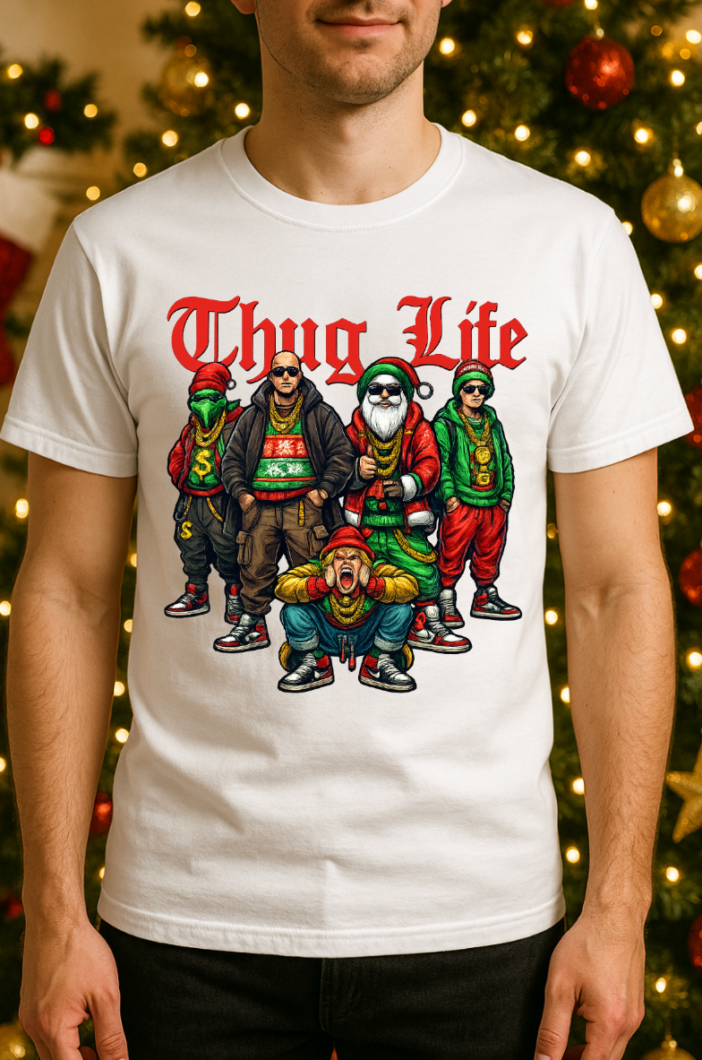 White “Thug Life” Christmas crew graphic tee displayed on a model standing in front of a decorated Christmas tree with lights and ornaments.