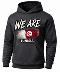 A dark charcoal gray hoodie featuring a distressed graphic print of the Tunisian flag with the text 'WE ARE' above and 'TUNISIA' below, displayed on a clean white background.