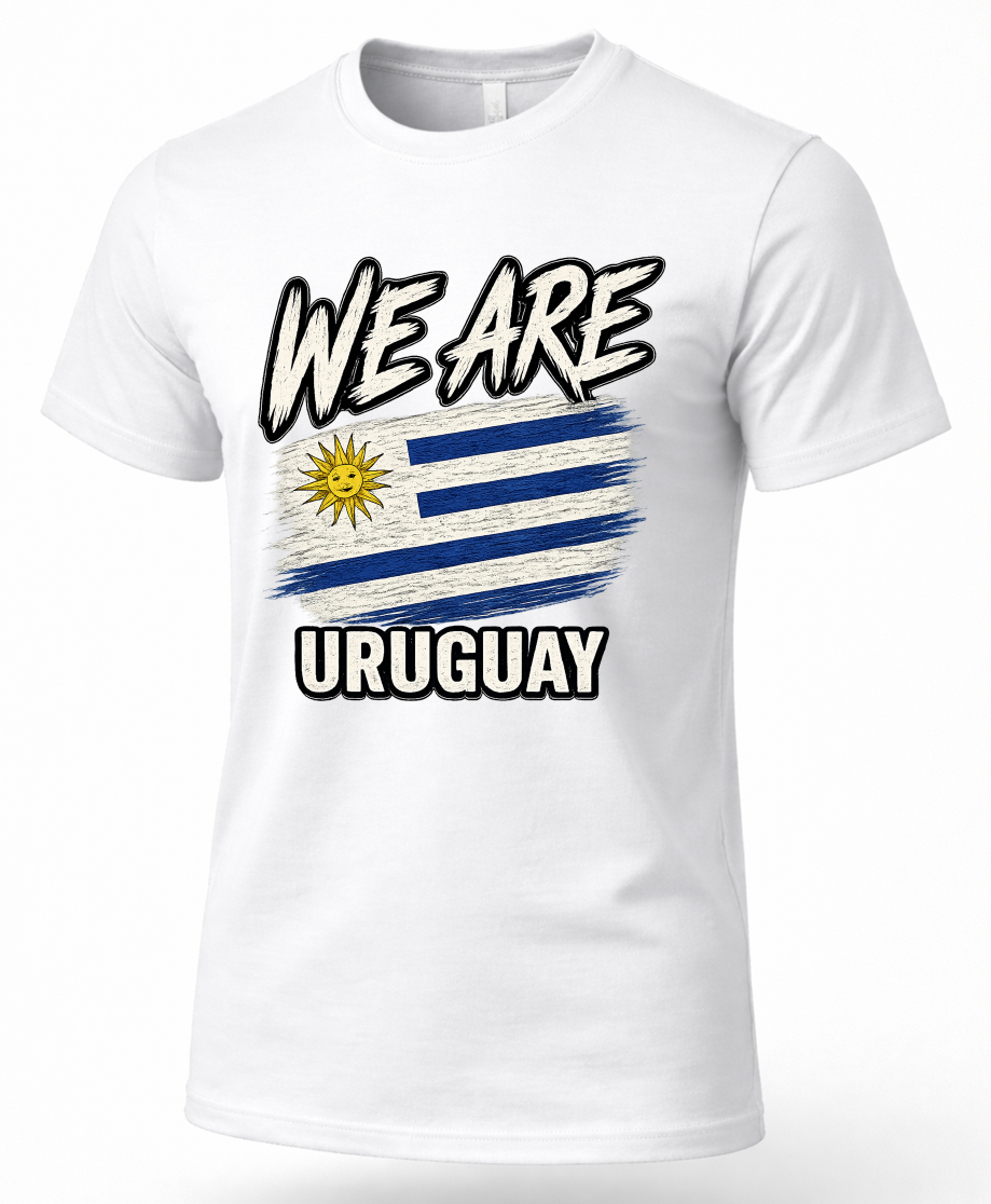 A white short-sleeve crewneck t-shirt featuring a graphic print of the Uruguay flag with the text 'WE ARE URUGUAY' in a bold, stylized font.