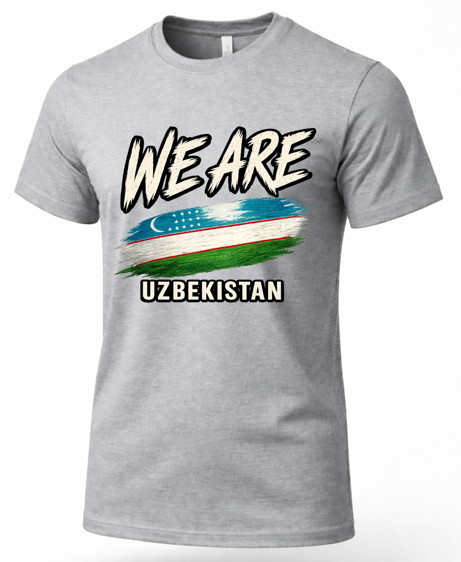 A heather gray short-sleeve t-shirt with a graphic print on the front. The design features the text 'WE ARE' in a stylized white font with black outlines, a distressed horizontal flag of Uzbekistan in the center, and 'UZBEKISTAN' printed below in white block letters with a black outline.