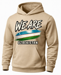 A beige pullover hoodie with a graphic print on the front. The design features the text 'WE ARE' in a bold, black-and-white brush-stroke font above a stylized, distressed flag of Uzbekistan, and 'UZBEKISTAN' printed below in white block letters with a black outline.