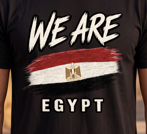 A close-up of a black t-shirt featuring a graphic print of the Egyptian flag with a gold eagle emblem, the text 'WE ARE' above, and 'EGYPT' below in a distressed white font.