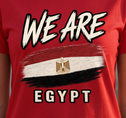A close-up of a red short-sleeve t-shirt featuring a graphic print of the Egyptian flag with a gold eagle emblem, and the text 'WE ARE EGYPT' in white with black outlines.