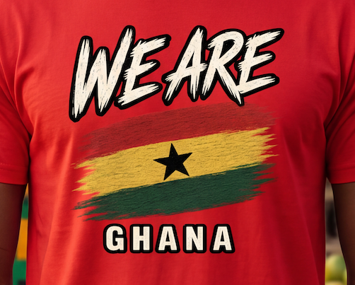 A close-up of a red t-shirt featuring a graphic print with the text 'WE ARE GHANA' and a stylized Ghana flag. The background is a blurred outdoor scene.