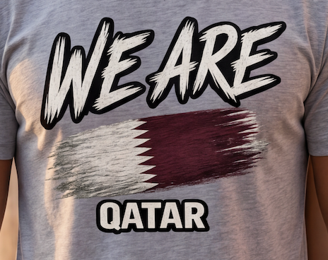 A close-up of a person wearing a heather gray t-shirt with a graphic print that reads 'WE ARE QATAR' above and below a stylized Qatar flag design.