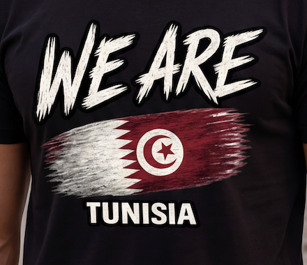 A close-up of a black t-shirt featuring a graphic print with the text 'WE ARE' above a stylized flag of Tunisia, and 'TUNISIA' below in white.