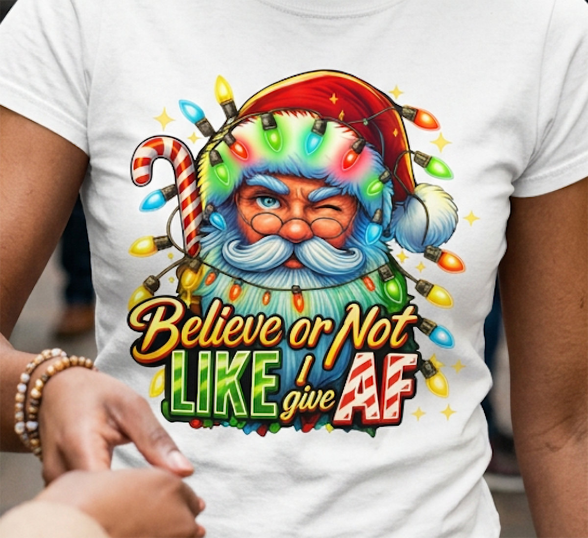 White Close-Up: Detailed view of the Believe or Not Like I Give AF Christmas design printed on white fabric with vibrant holiday colors.