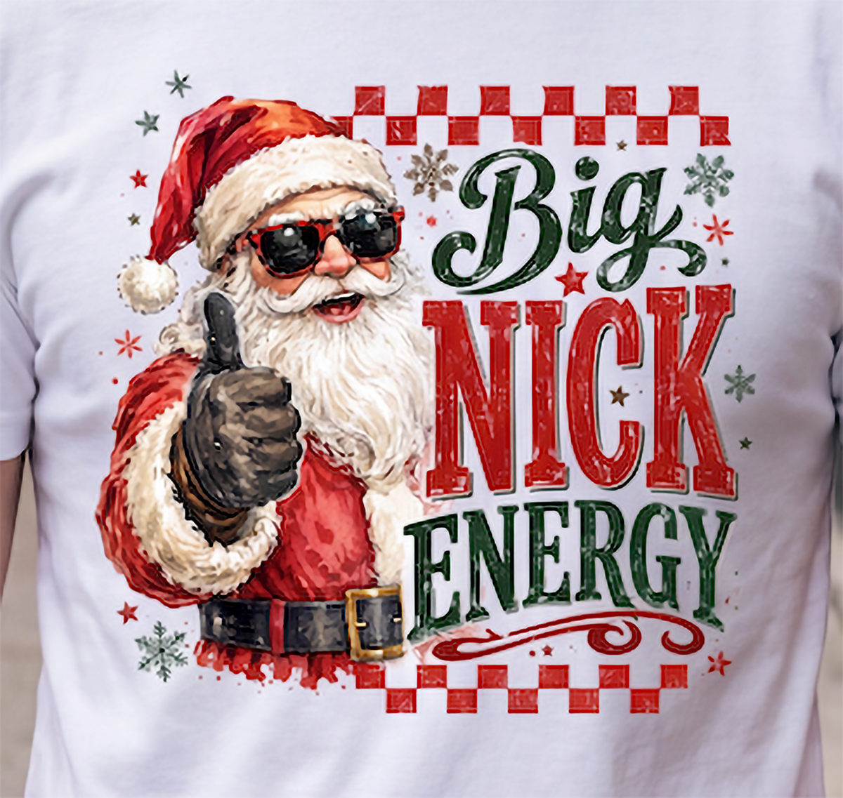 Close-up of Big Nick Energy Santa Christmas graphic on white shirt