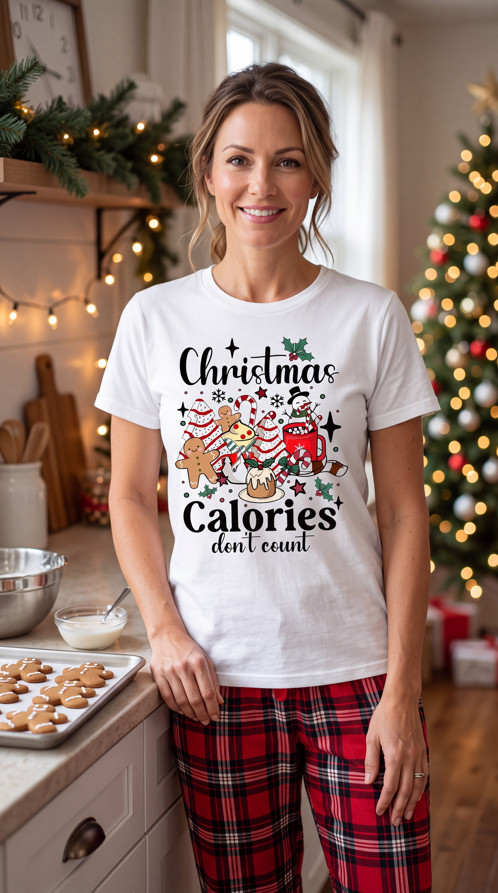 Woman wearing white Christmas Calories Don’t Count shirt featuring gingerbread cookies, cocoa, candy canes and festive holiday treats.