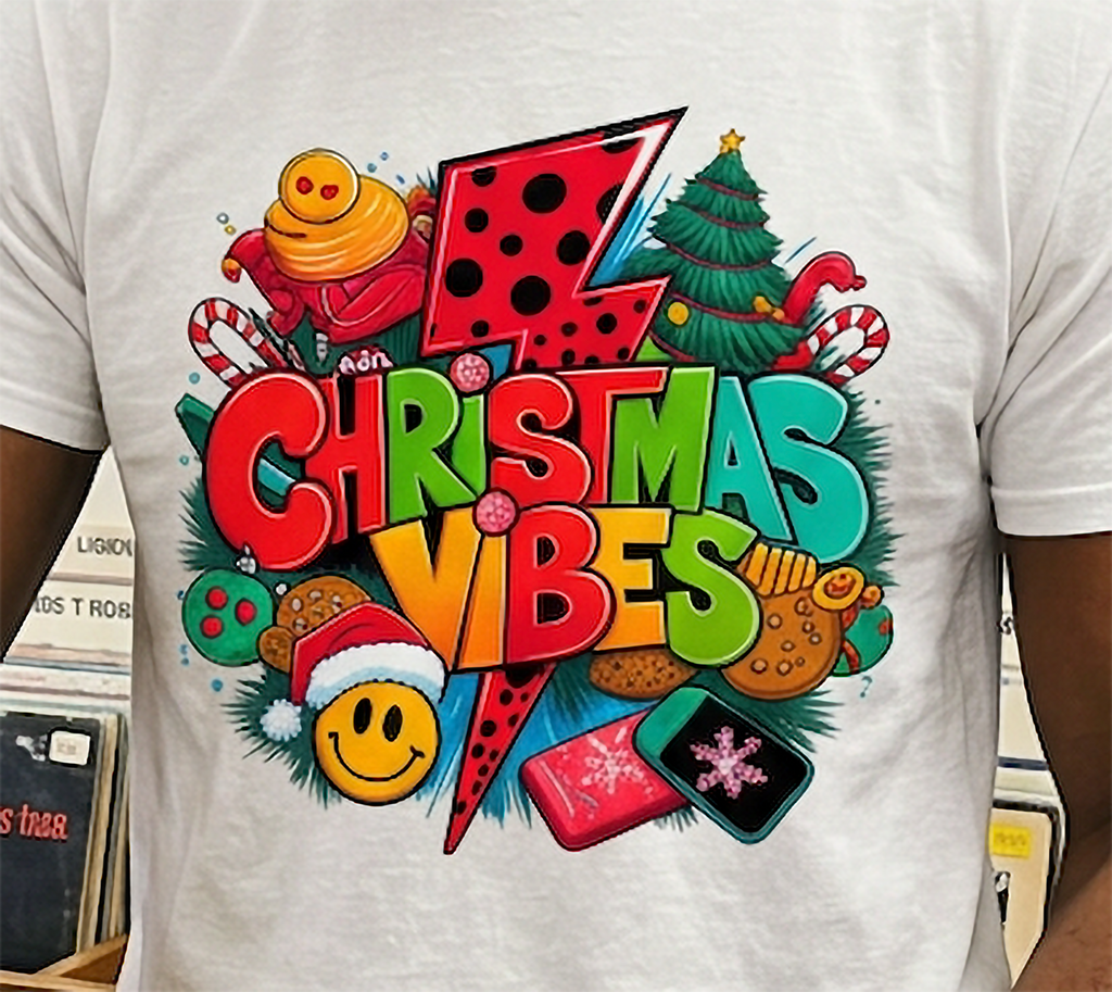 White Design Close-Up: Detailed close-up of colorful Christmas Vibes graphic printed on a white t-shirt with Christmas tree, candy canes, and retro holiday accents.