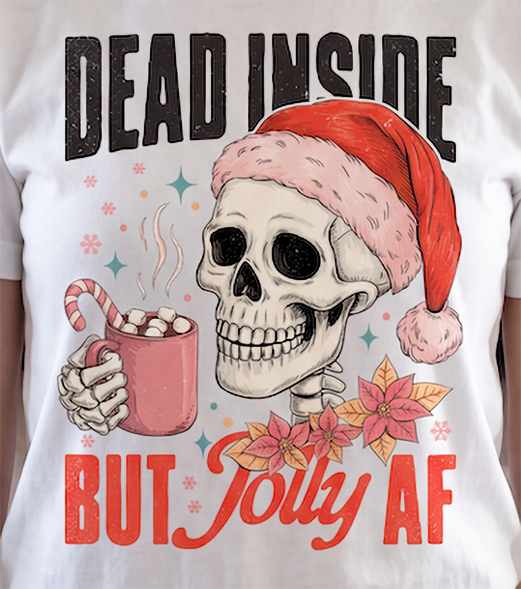 Close-up of Dead Inside But Jolly AF Christmas skeleton graphic printed on white shirt.