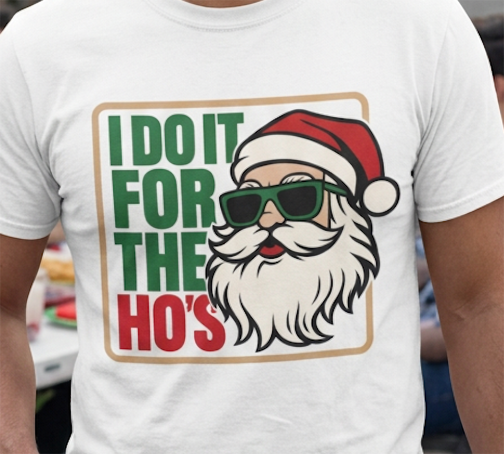 Close-up of white Christmas t-shirt featuring naughty Santa humor design with red and green lettering.