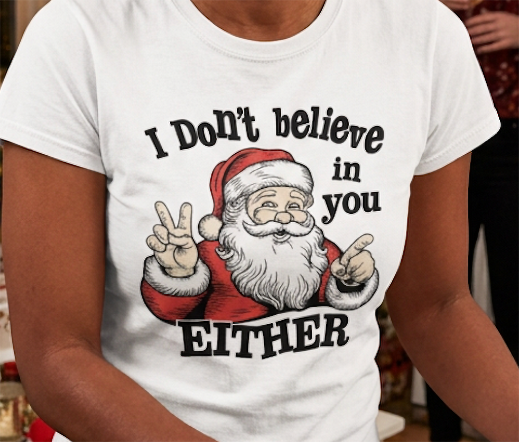 Close-up of white funny Christmas graphic tee featuring Santa Claus pointing and I Don't Believe in You Either text.