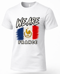 A white short-sleeve crewneck t-shirt featuring a graphic print of the French flag with a golden rooster emblem, accompanied by the text 'WE ARE FRANCE' in a stylized black and white font.