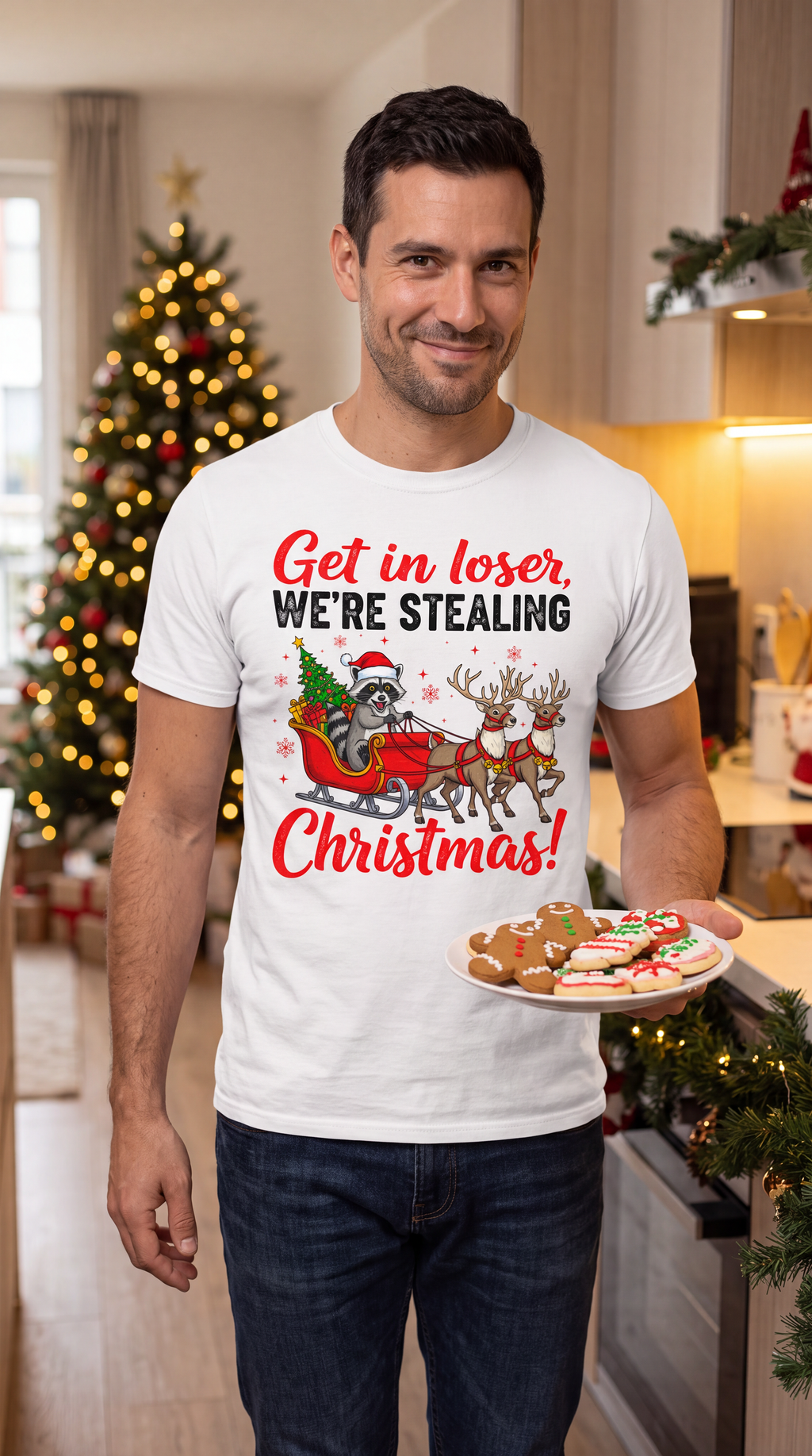 Man wearing a white Get in Loser We’re Stealing Christmas graphic tee in a festive holiday setting