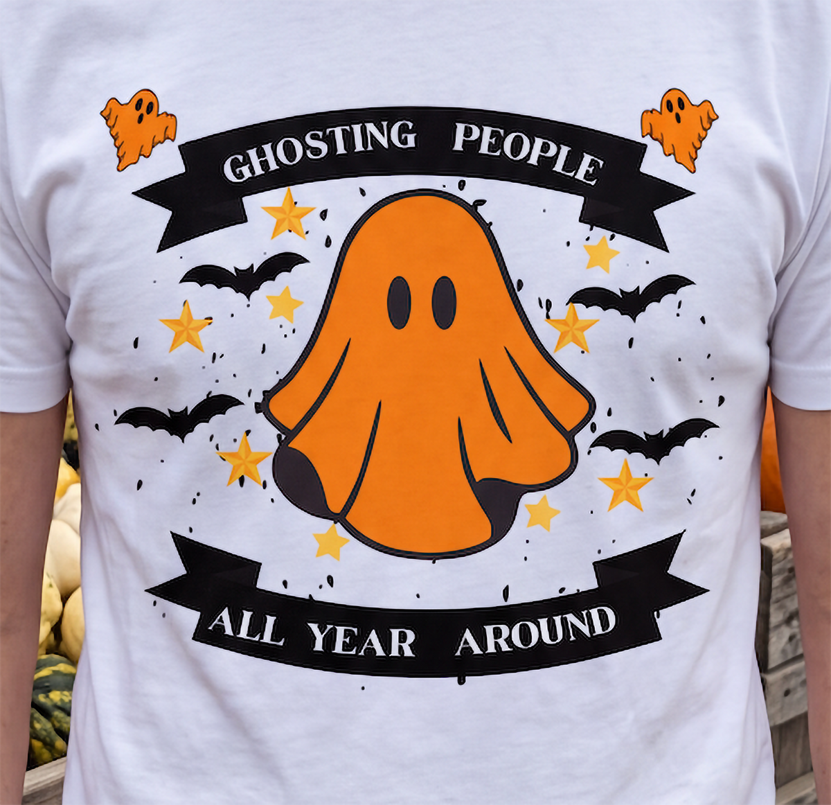Close-up of white Ghosting People Halloween shirt with orange ghost and bats design