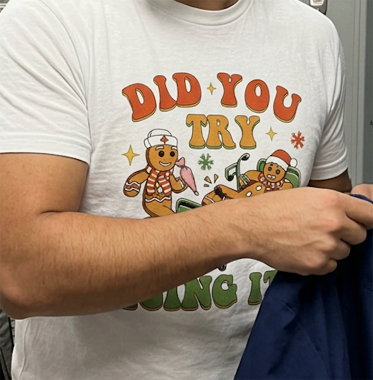 Close-up of Did You Try Icing It Christmas graphic on a white unisex holiday t-shirt.