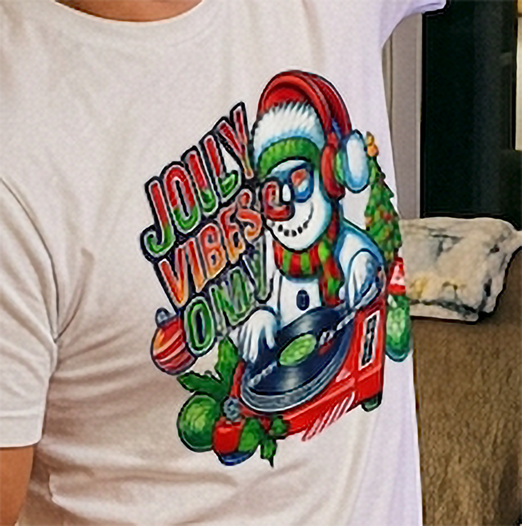 White Close-Up: Close-up of festive snowman DJ Christmas artwork printed on a sand-colored holiday graphic tee.