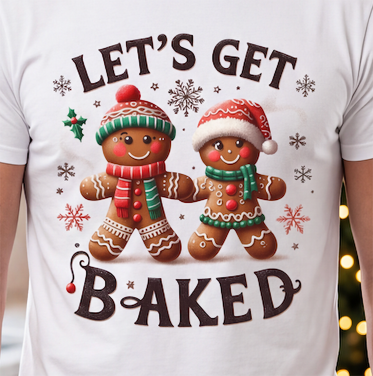 Close-up of Let’s Get Baked Christmas gingerbread design printed on white graphic tee.