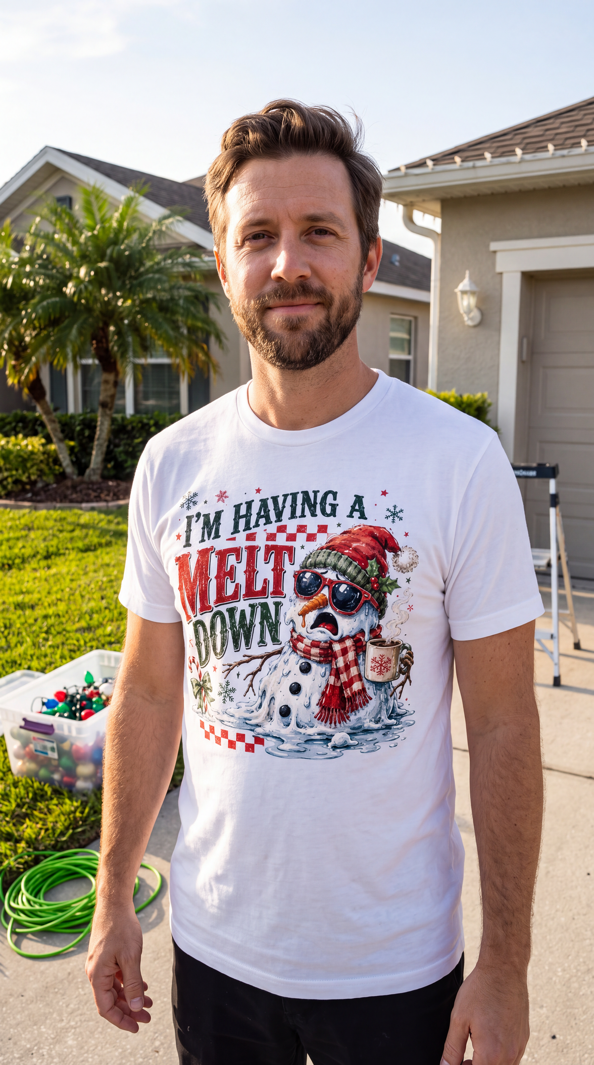 Man wearing white I’m Having a Meltdown Christmas graphic tee outdoors in a casual holiday outfit