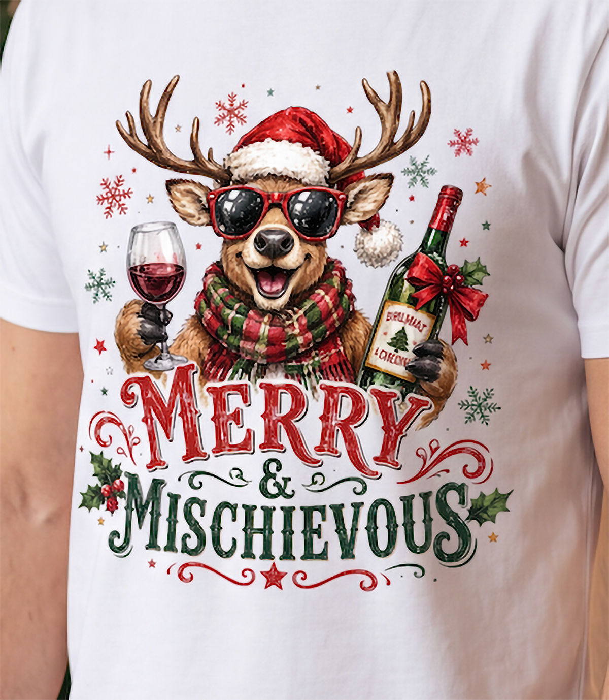 Close-up of white Merry & Mischievous Christmas shirt showing festive reindeer and wine graphic.