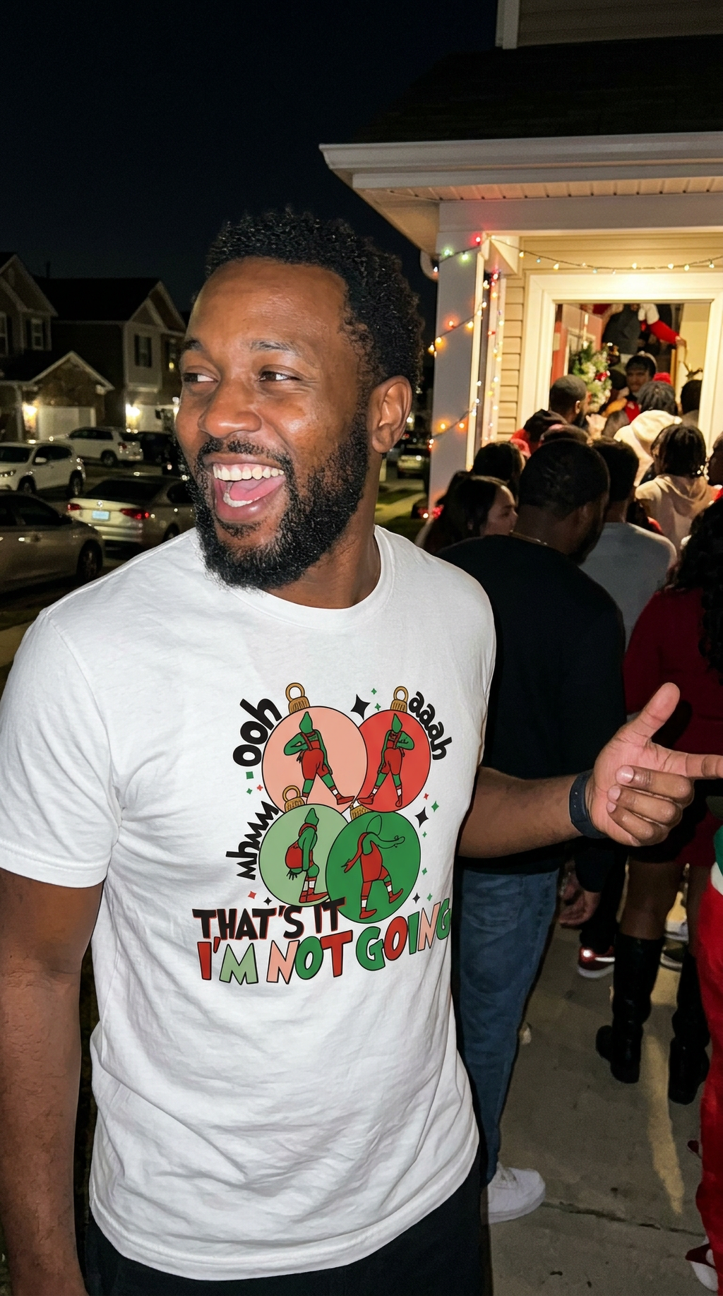 White Lifestyle: Man wearing a white That's It I'm Not Going Grinch Christmas graphic t-shirt at an outdoor holiday gathering.