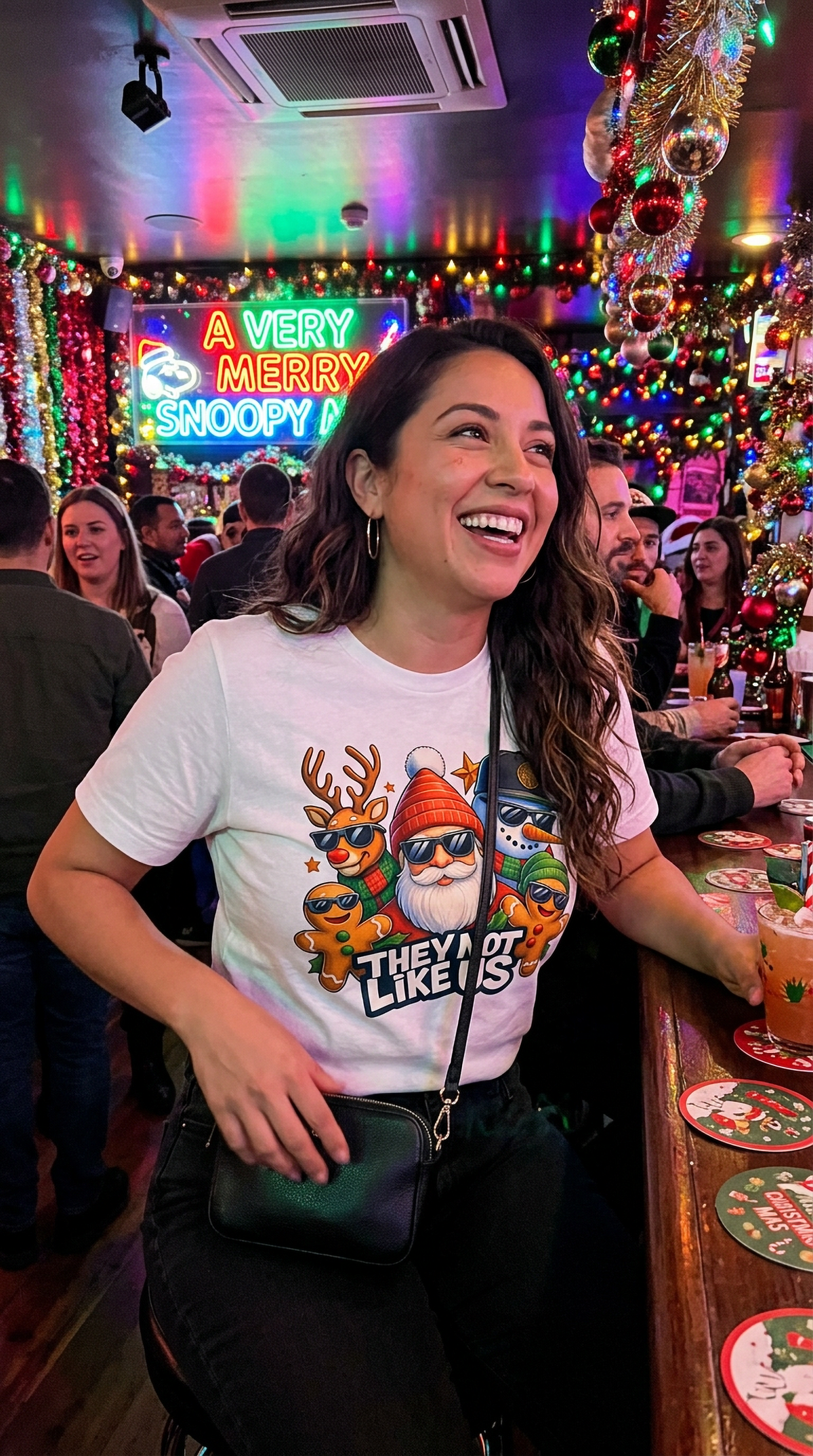 Woman wearing white They Not Like Us Christmas graphic t-shirt at a colorful holiday market with festive decorations.