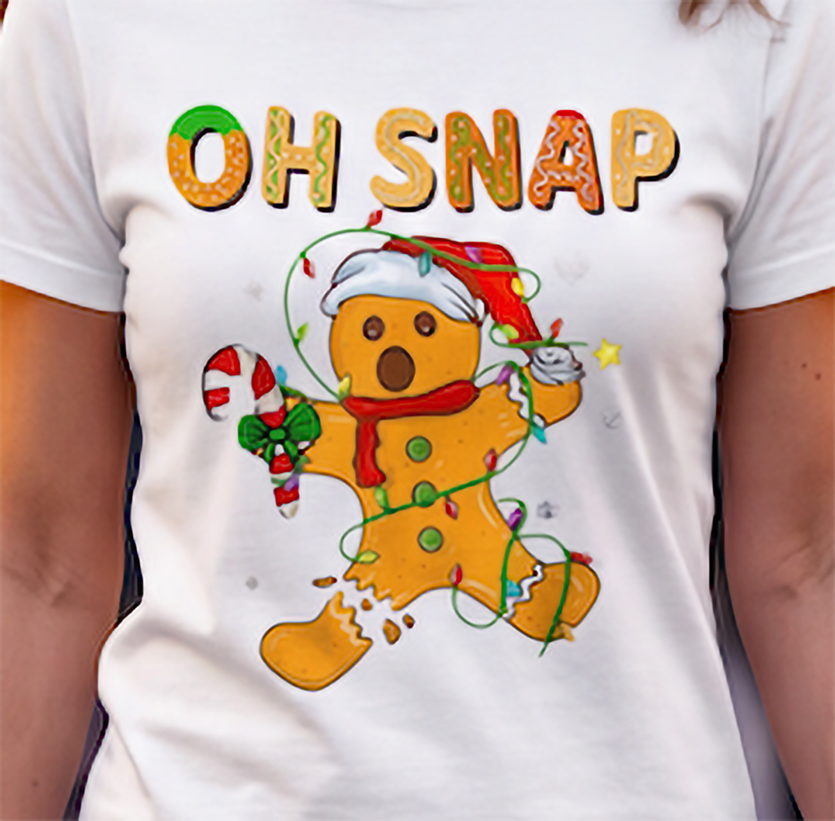Close-up of Oh Snap gingerbread man holiday graphic on white shirt