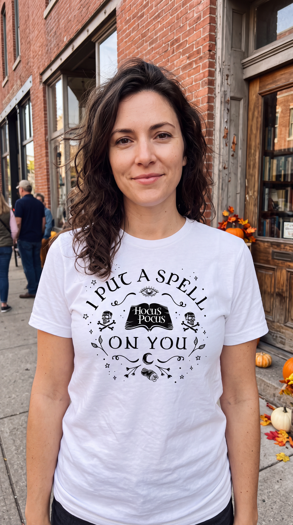 Woman wearing white Hocus Pocus I Put a Spell on You Halloween shirt