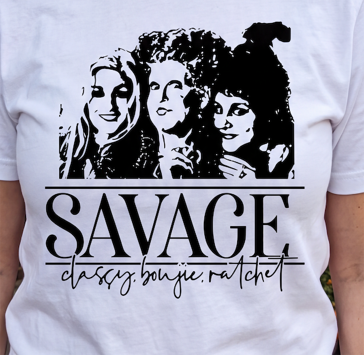 Close-up of white Savage Hocus Pocus shirt with Sanderson Sisters Halloween design