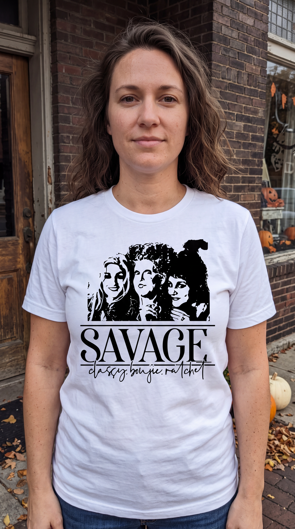 Woman wearing white Savage Hocus Pocus Sanderson Sisters Halloween shirt outdoors