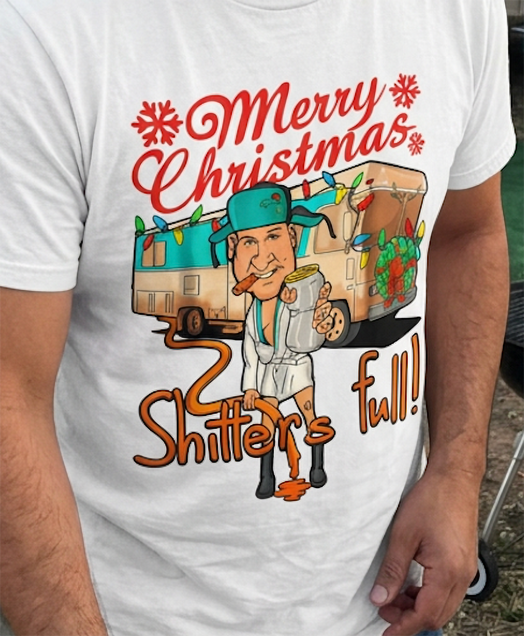 White Design Close-Up: Close-up of white Christmas graphic tee showing red Merry Christmas lettering, festive camper artwork, and Shitter's Full design.