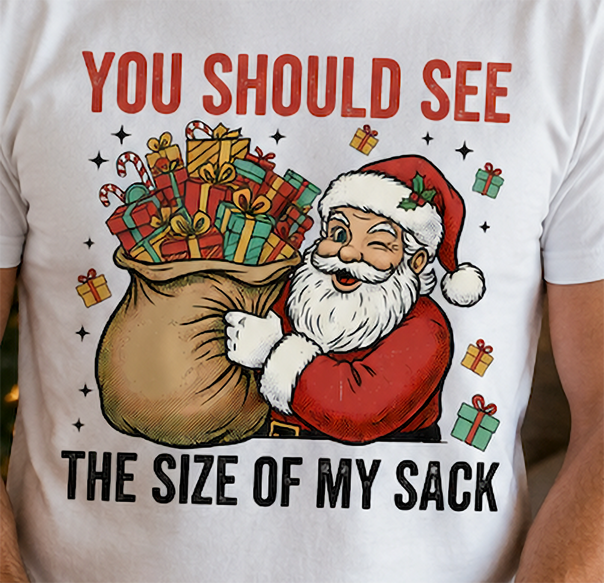 Close-up of funny Santa Christmas sack graphic displayed on a white holiday shirt.