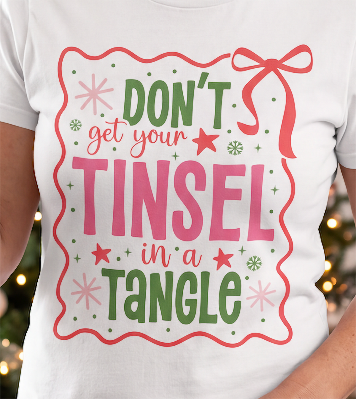 Close-up of Don’t Get Your Tinsel in a Tangle Christmas design printed on a white T-shirt.