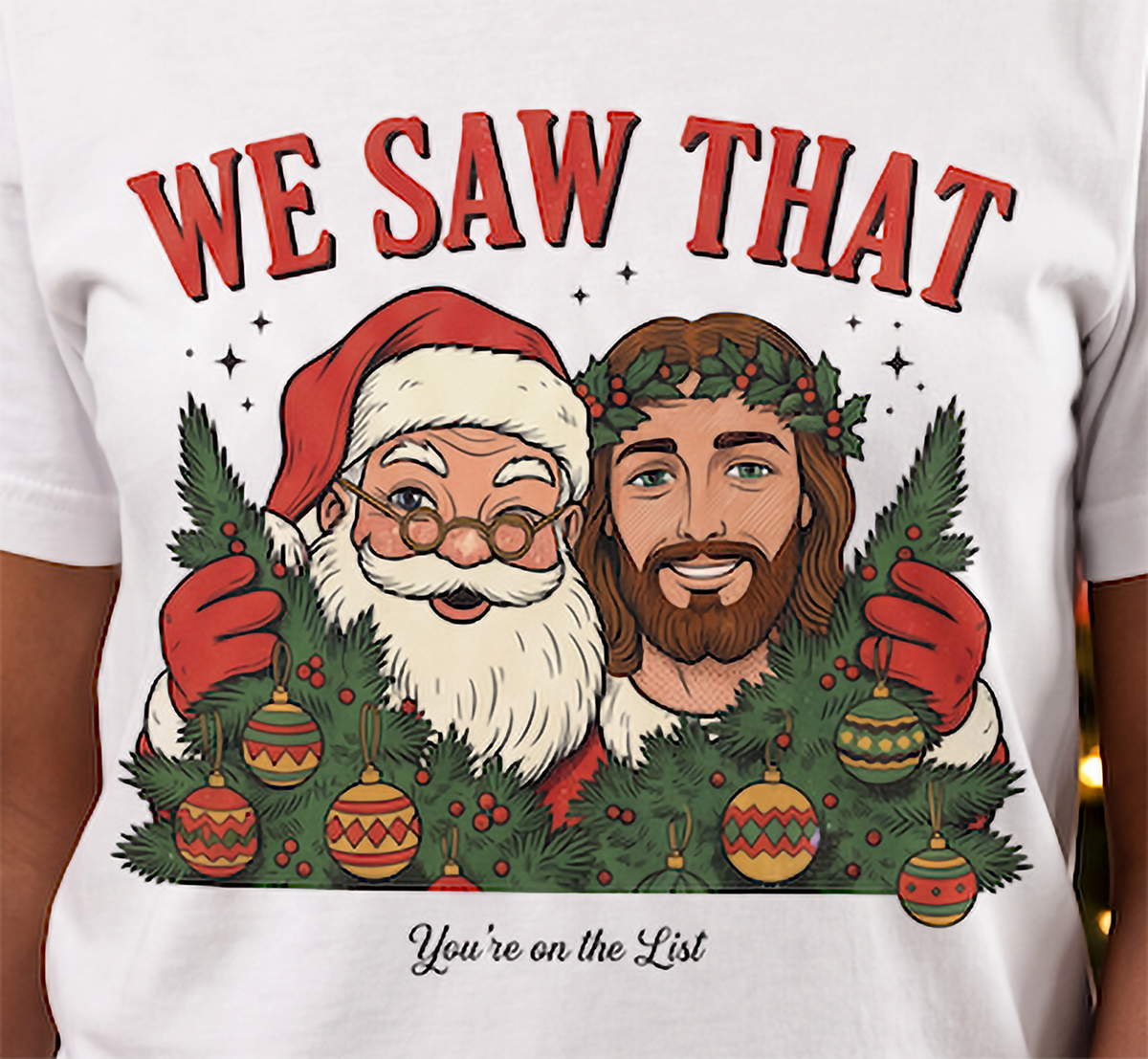 Close-up of We Saw That Santa and Jesus Christmas design on white shirt