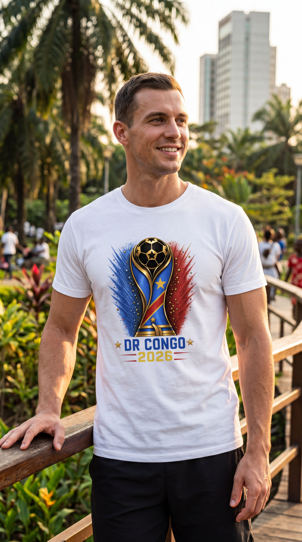 Man wearing a white t-shirt with a colorful design and text, standing outdoors with trees and buildings in the background.