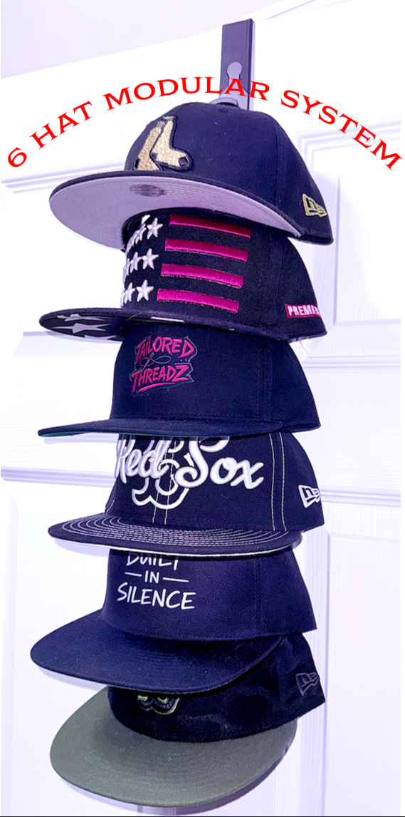 Stack of fitted baseball caps displayed on a modular over-door hat rack organizer for snapbacks and baseball cap storage system