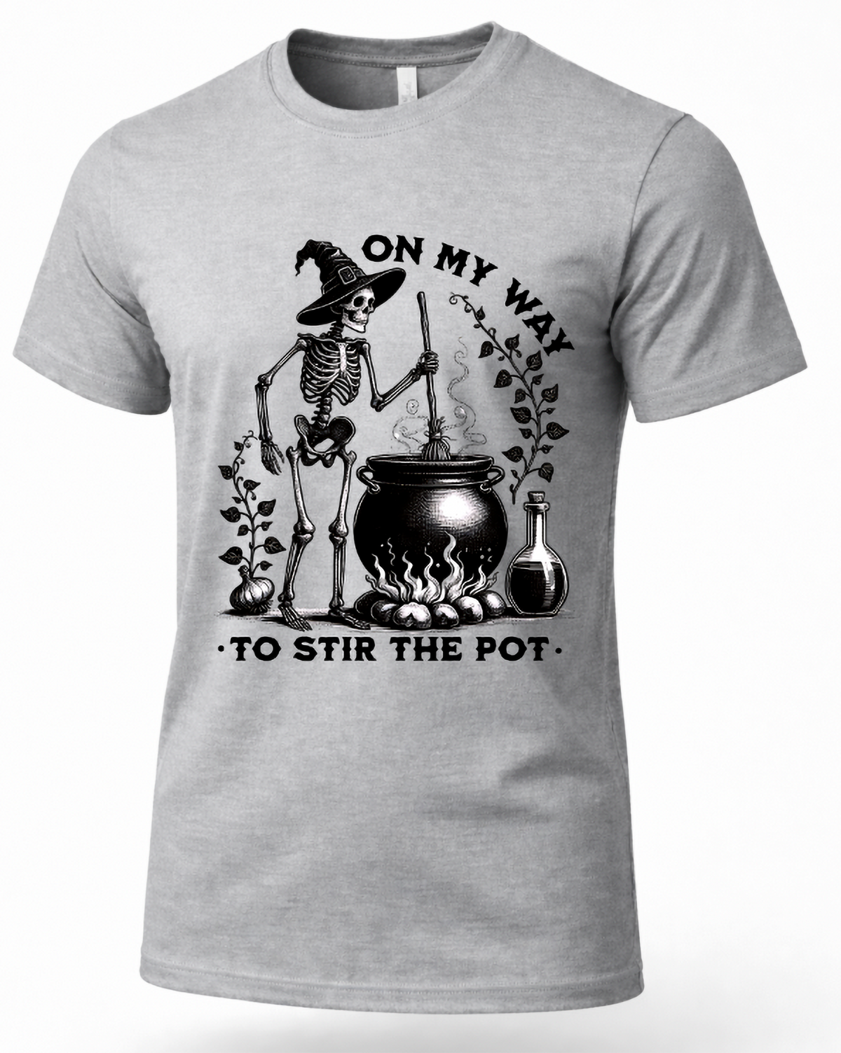 A light gray crewneck t-shirt featuring a black graphic of a skeleton wizard stirring a cauldron with the text 'ON MY WAY TO STIR THE POT'.